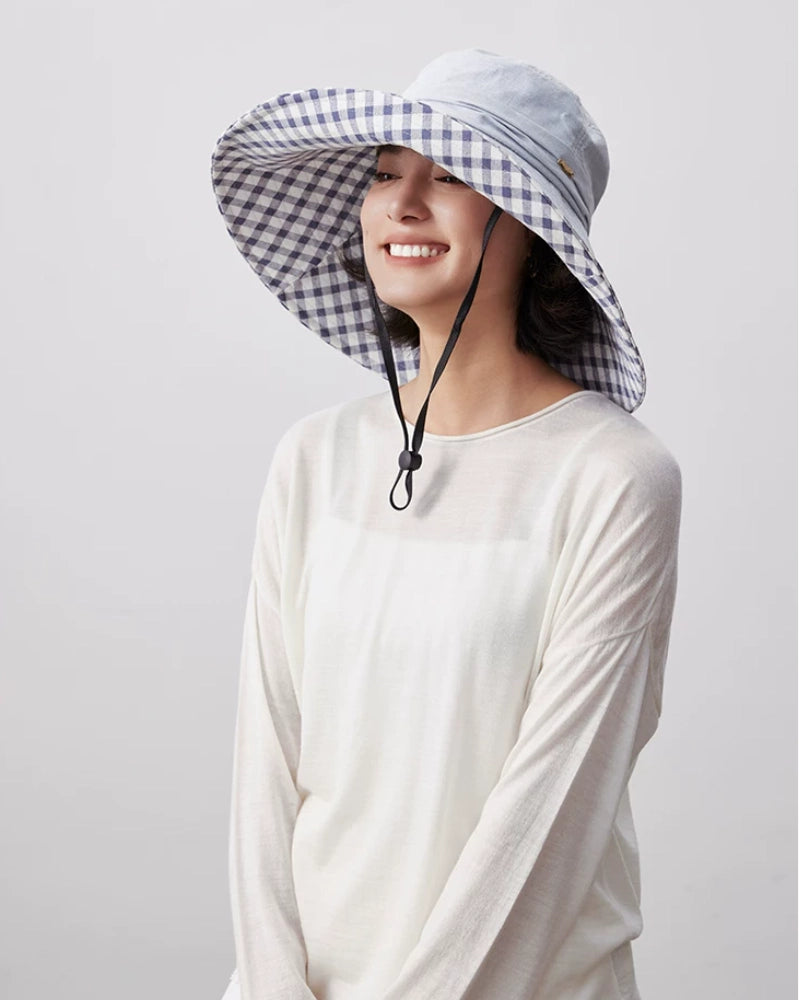 Light blue cotton wide brim sun hat with gingham plaid lining and adjustable chin strap for summer wear