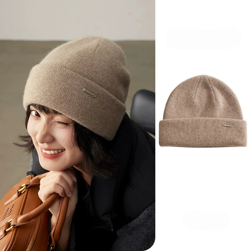 Smiling woman wearing a light coffee cashmere cuffed beanie with a matching product view
