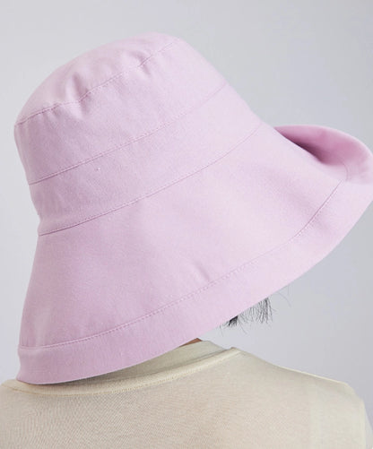 Back view of a light pink linen blend sun hat showing its wide wrap-around brim