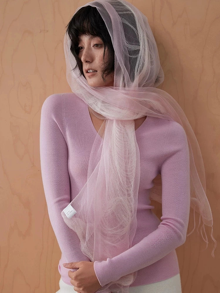 Light pink mulberry silk scarf styled as a sheer hood with flowing fringed ends