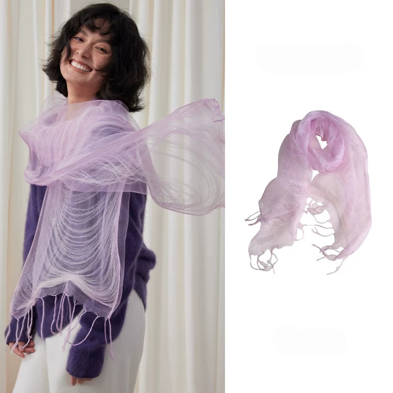 Woman wearing a light purple sheer mulberry silk fringe scarf over a purple sweater