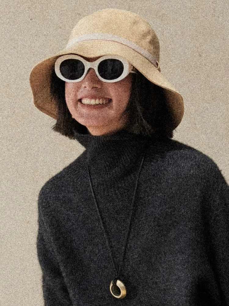 Light wheat packable bucket hat styled with sunglasses for travel beach and everyday sun protection
