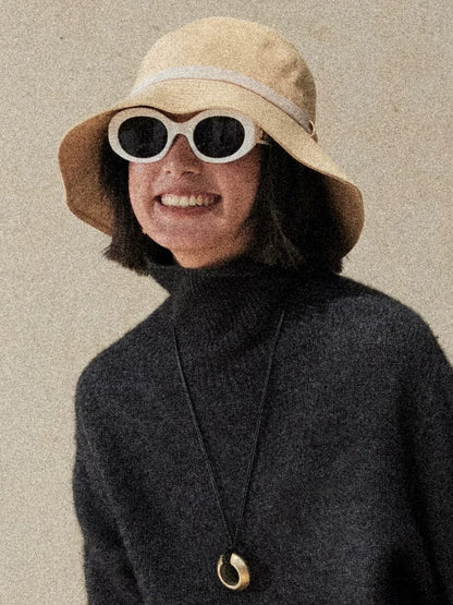 Light wheat packable bucket hat styled with sunglasses for travel beach and everyday sun protection
