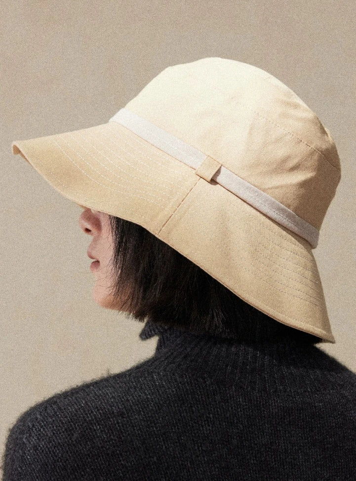 Back view of light wheat wide brim bucket hat with soft structure and refined casual outdoor style