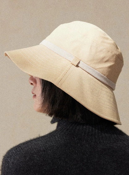 Back view of light wheat wide brim bucket hat with soft structure and refined casual outdoor style