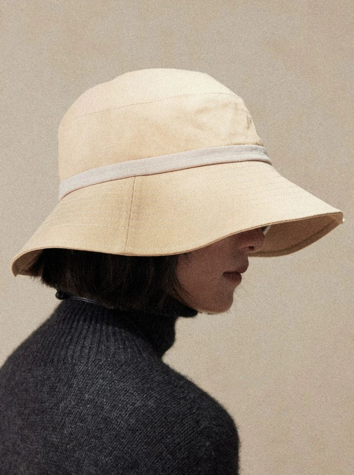 Side view of light wheat UV protection sun hat with wide brim and minimalist travel-ready design
