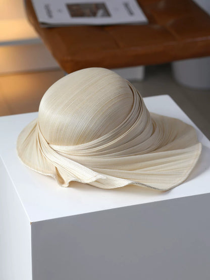 Natural Buntal straw wide brim sun hat with soft pleated draped brim.