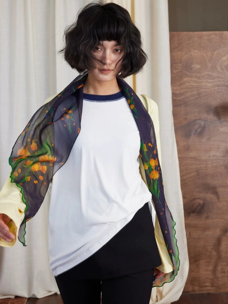 Model wearing midnight blue botanical silk georgette skinny scarf with casual outfit