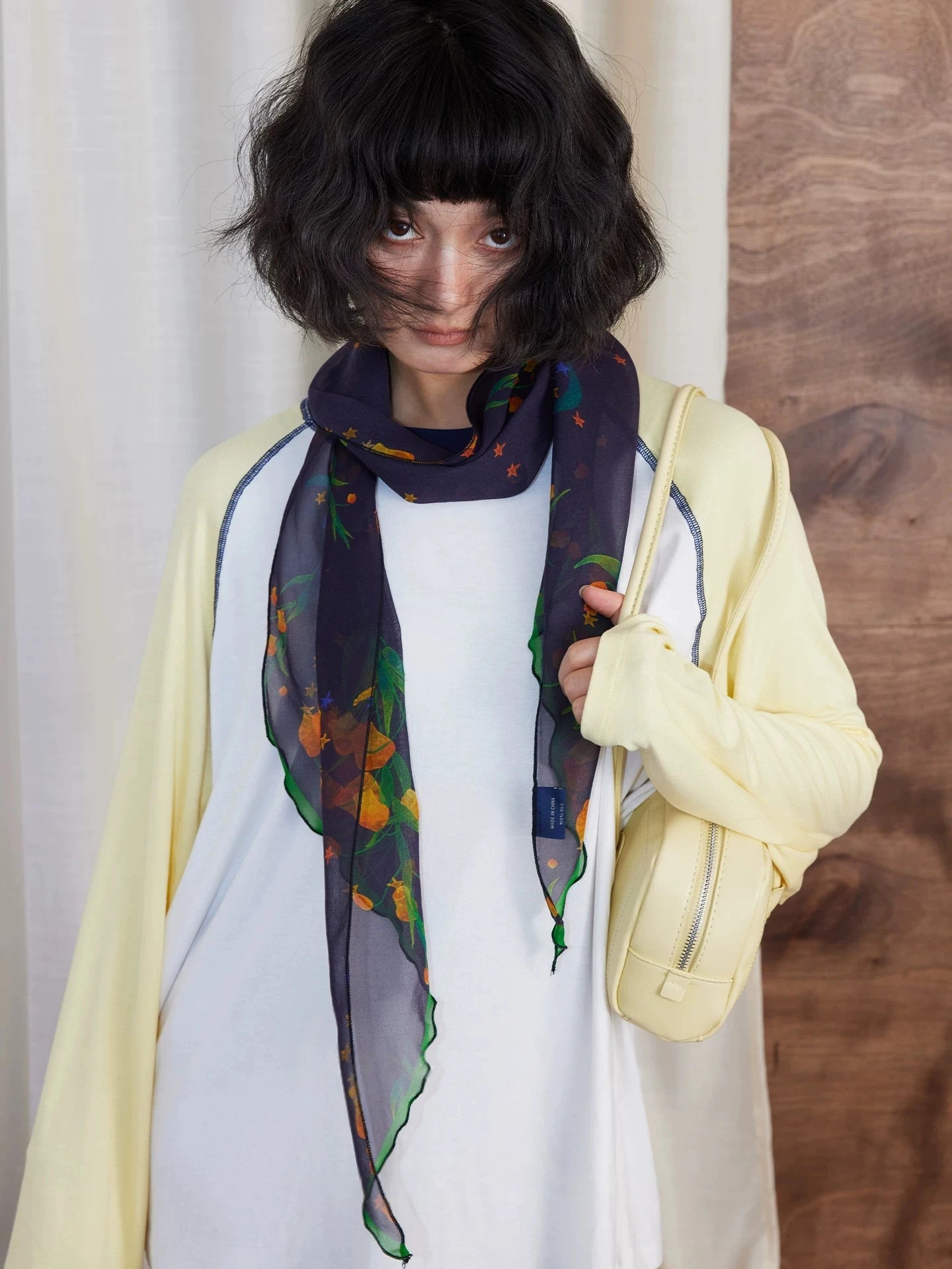 Midnight blue floral silk scarf styled with white top and yellow cardigan