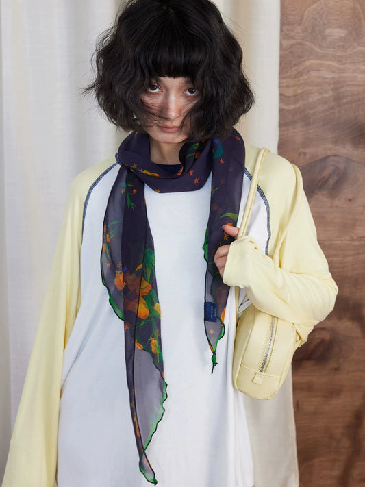 Midnight blue floral silk scarf styled with white top and yellow cardigan