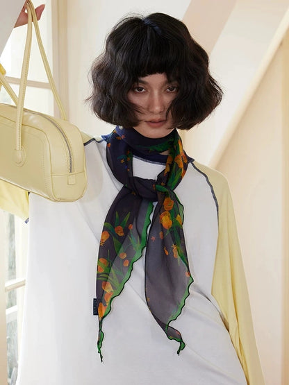 Midnight blue floral silk scarf tied softly as a neck ribbon