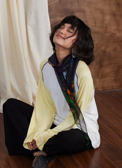 Model styling midnight blue botanical silk georgette scarf in a relaxed outfit