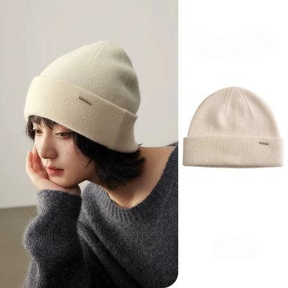 Woman wearing a milk white cashmere cuffed beanie with a matching product view