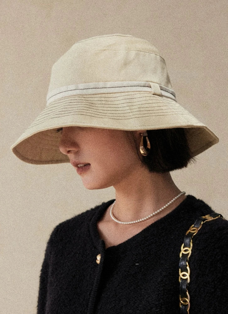 Front view of milky apricot wide brim sun hat with face shading and elegant summer styling