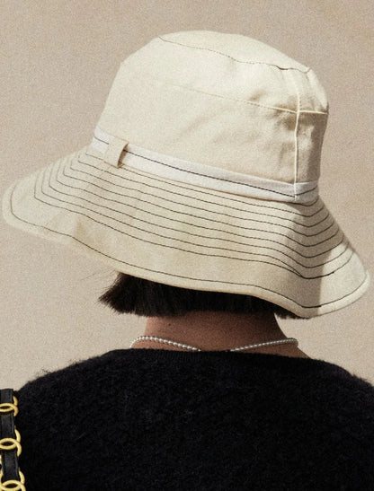 Back view of milky apricot bucket hat with adjustable detail and wide brim UV protection