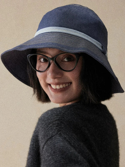 Mist blue bucket hat styled with glasses for casual travel outdoor wear and everyday sun protection