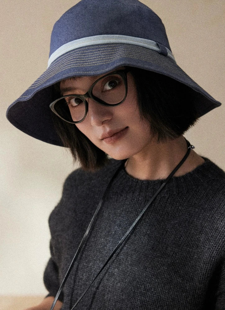 Mist blue packable bucket hat with wide brim for face shading and refined outdoor sun care