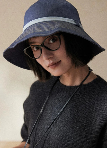 Mist blue packable bucket hat with wide brim for face shading and refined outdoor sun care