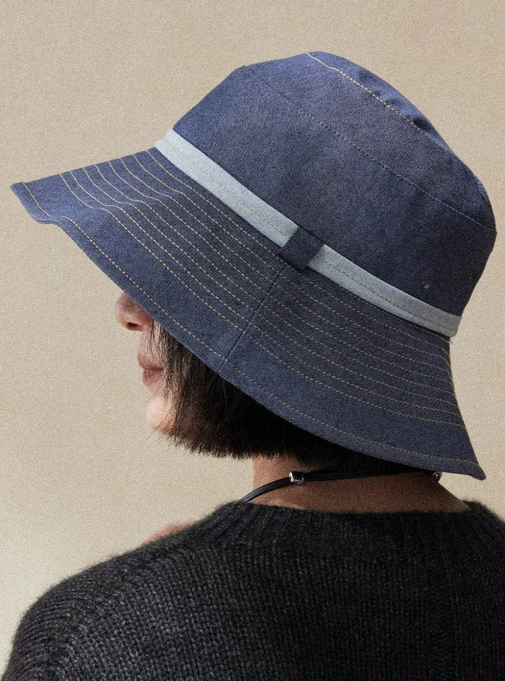 Side view of mist blue wide brim bucket hat with contrast band and minimalist casual style