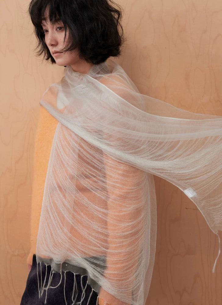 Sheer mist gray mulberry silk scarf flowing across a warm-toned outfit