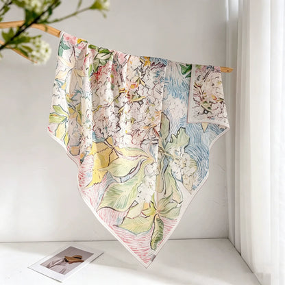 Monet-inspired floral mulberry silk square scarf displayed open with a soft pastel watercolor print