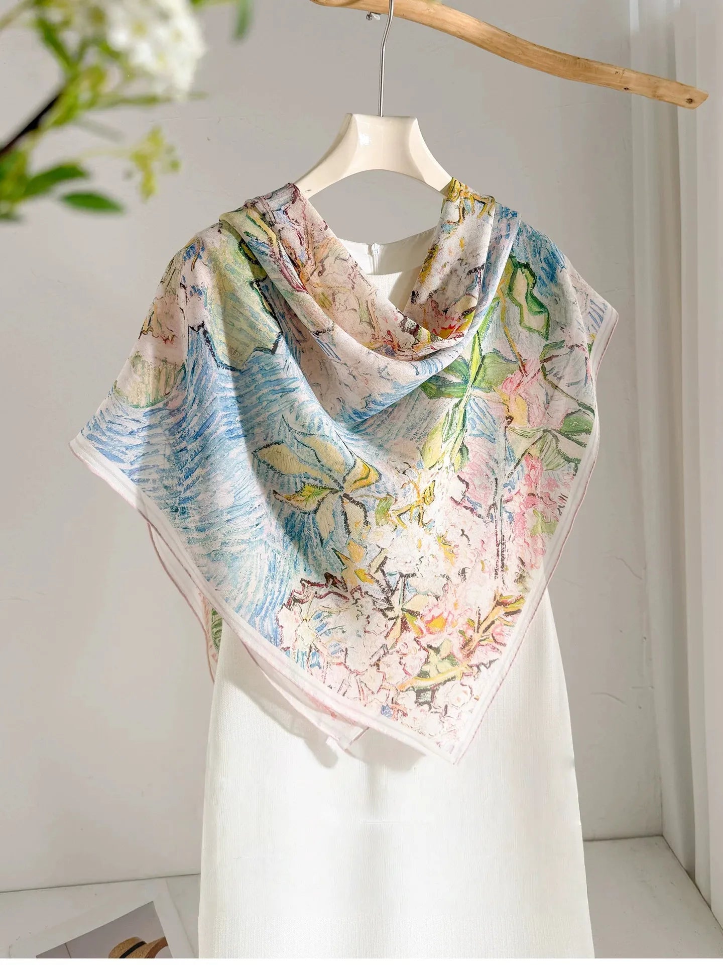 Large floral silk square scarf styled in a front triangle over a white dress