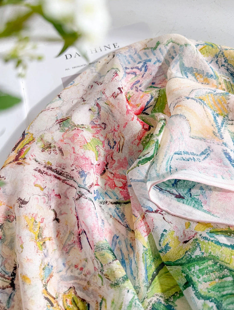 Close-up of sheer mulberry silk georgette with watercolor flowers in soft pastel tones