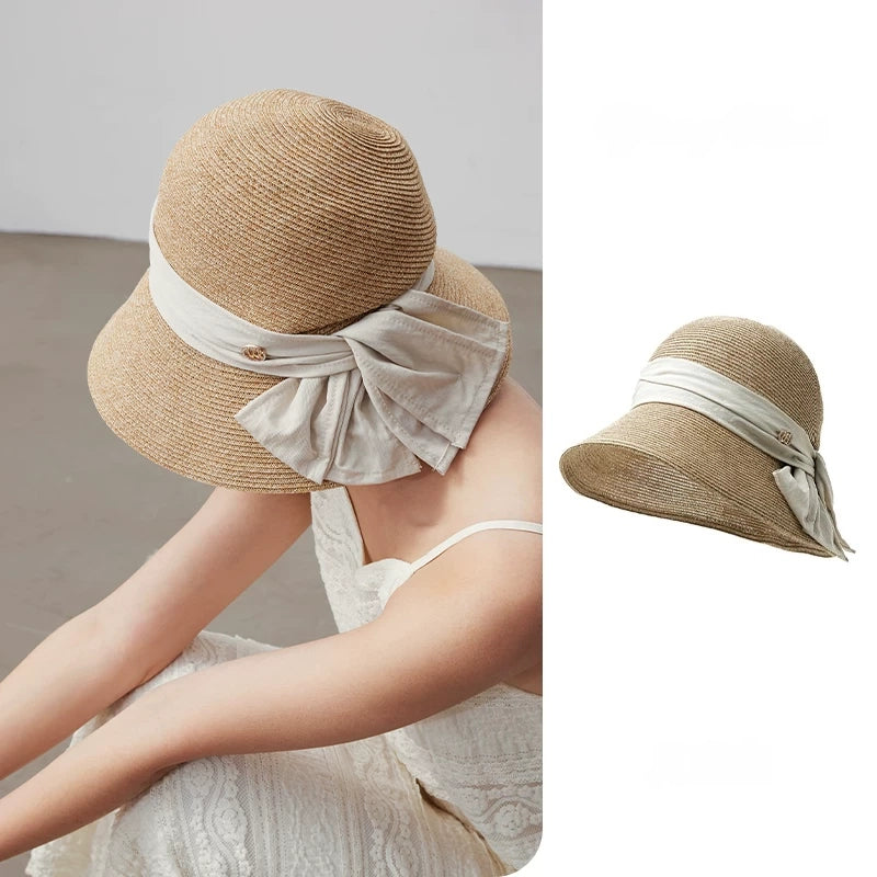 Moonlight white straw sun hat with wide brim and bow ribbon detail, shown in a soft summer styling view.
