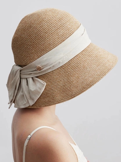 Moonlight white straw sun hat with back bow ribbon detail, designed for resort outfits and elegant outdoor styling.