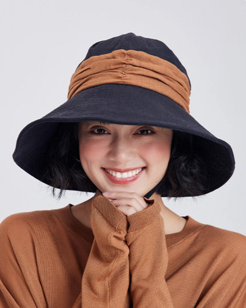 Model wearing a black brown ramie wide brim sun hat with foldable design for summer outdoor style.