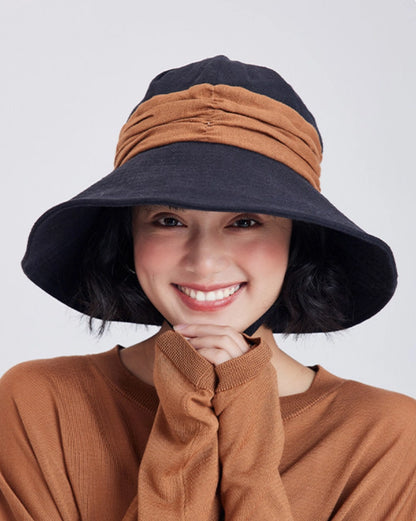 Model wearing a black brown ramie wide brim sun hat with foldable design for summer outdoor style.