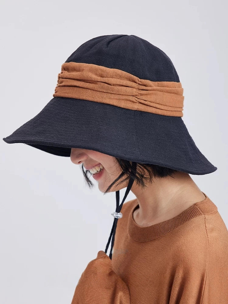 Side view of black brown natural ramie sun hat with wide brim and lightweight breathable fabric.