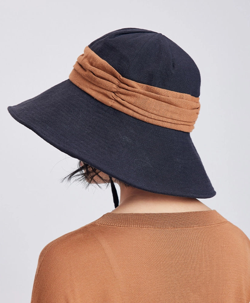 Back view of black brown ramie bucket hat with contrast band, foldable brim, and relaxed outdoor style.