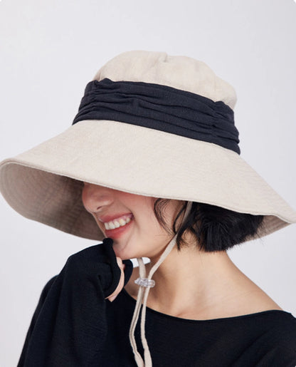 Ivory beige wide brim bucket hat with breathable ramie cotton fabric for beach, travel, and outdoor summer wear.