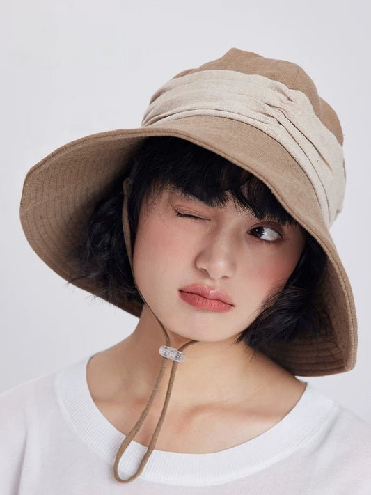 Khaki wide brim bucket hat with breathable ramie cotton fabric, wind cord, and relaxed summer styling.