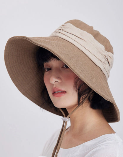 Side view of khaki natural ramie sun hat with wide brim and lightweight foldable design for travel.