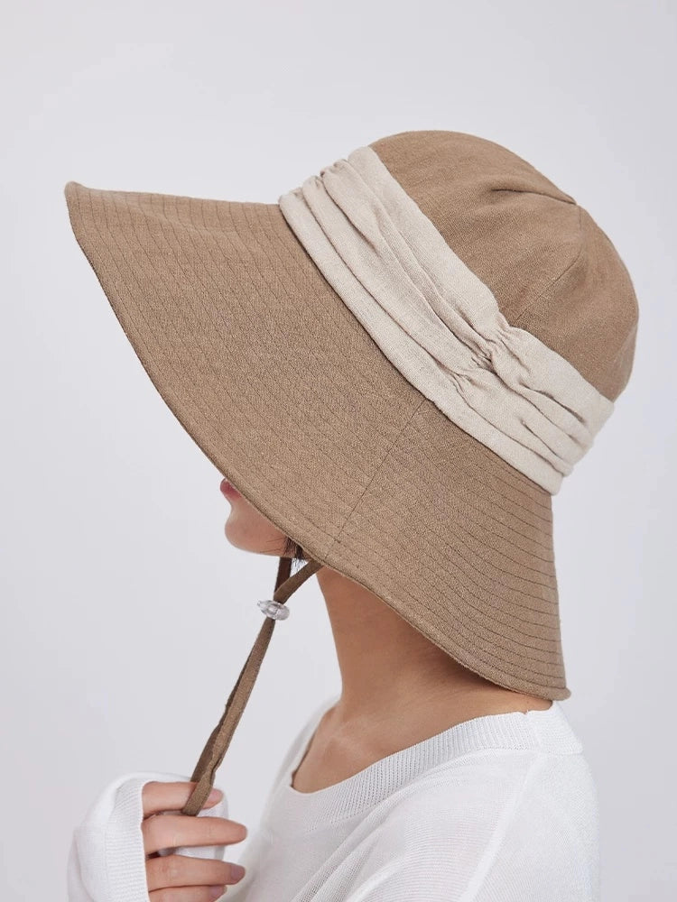 Profile view of khaki foldable wide brim bucket hat with wind cord for city walks, gardening, and beach days.