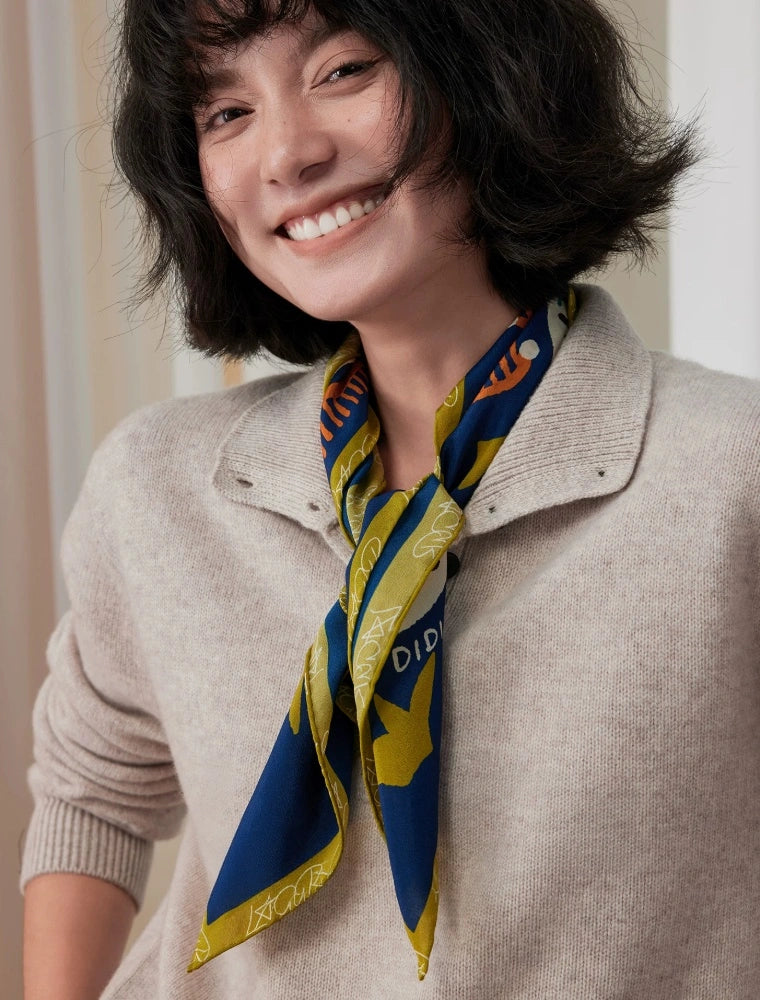 Model wearing a navy blue leopard mulberry silk scarf as a classic triangular neckerchief