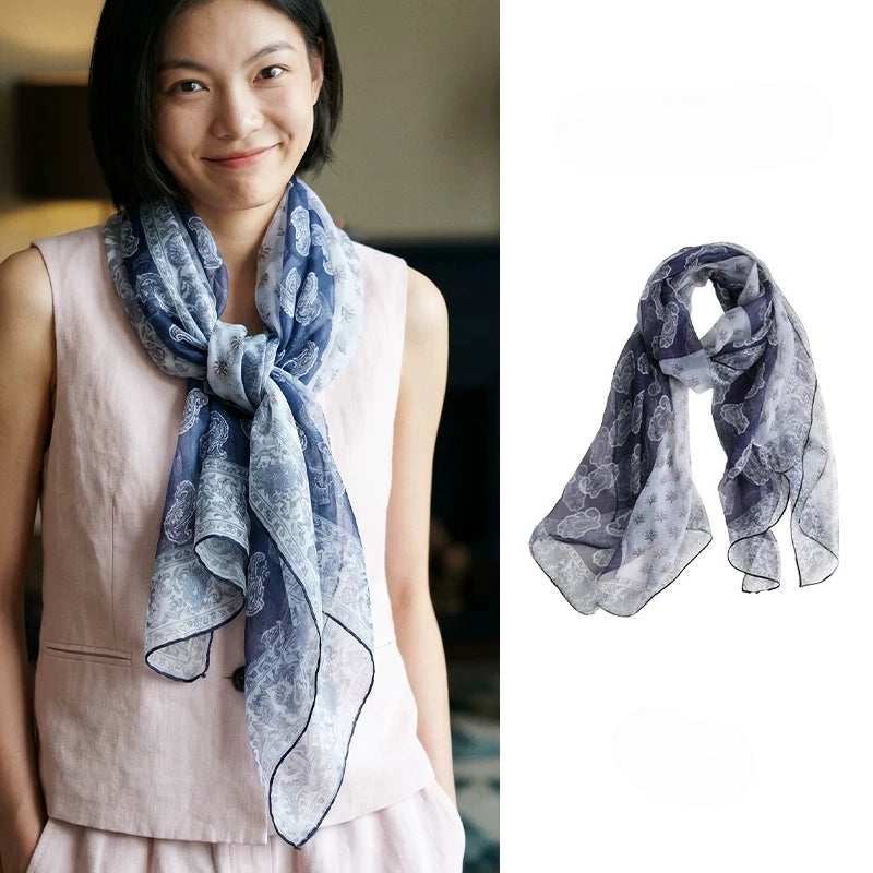 Woman wearing a navy paisley mulberry silk chiffon scarf with product view