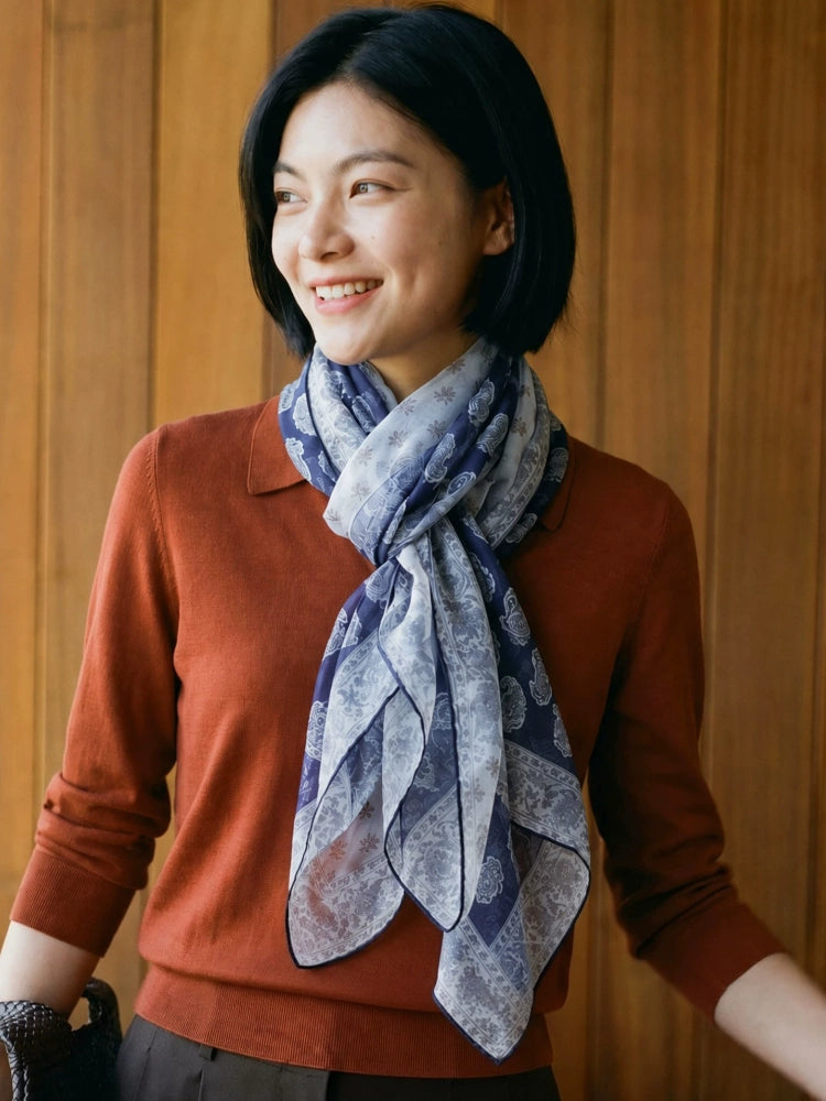 Navy paisley mulberry silk scarf styled with a rust-colored sweater