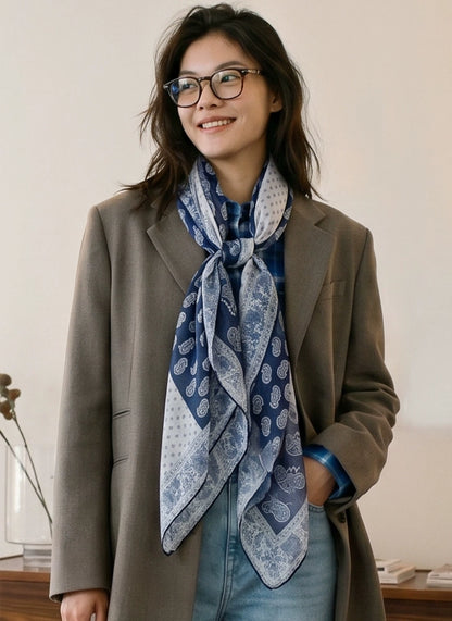 Elegant navy silk neck scarf paired with a tailored blazer for work