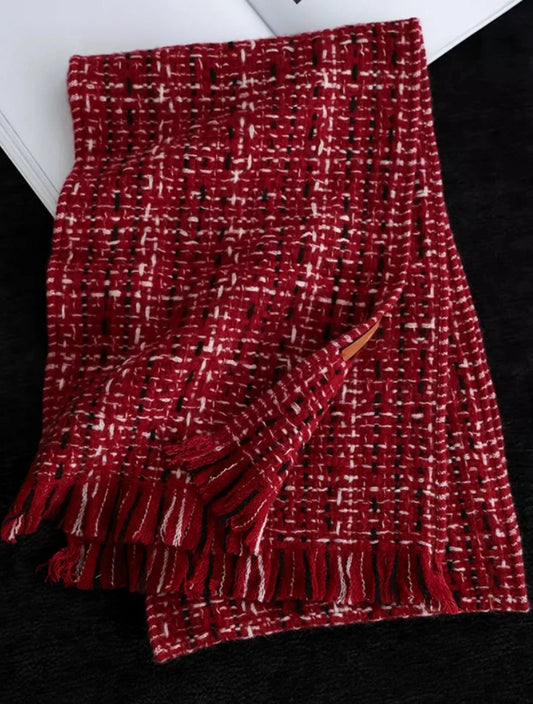 New Year red cashmere tweed scarf folded flat, showing contrasting white checks and fringed ends.