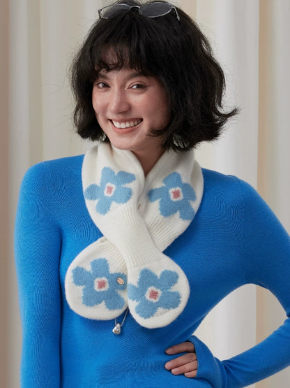 Ivory and blue floral wool keyhole scarf worn crossed at the front, with the model's hand on her hip.