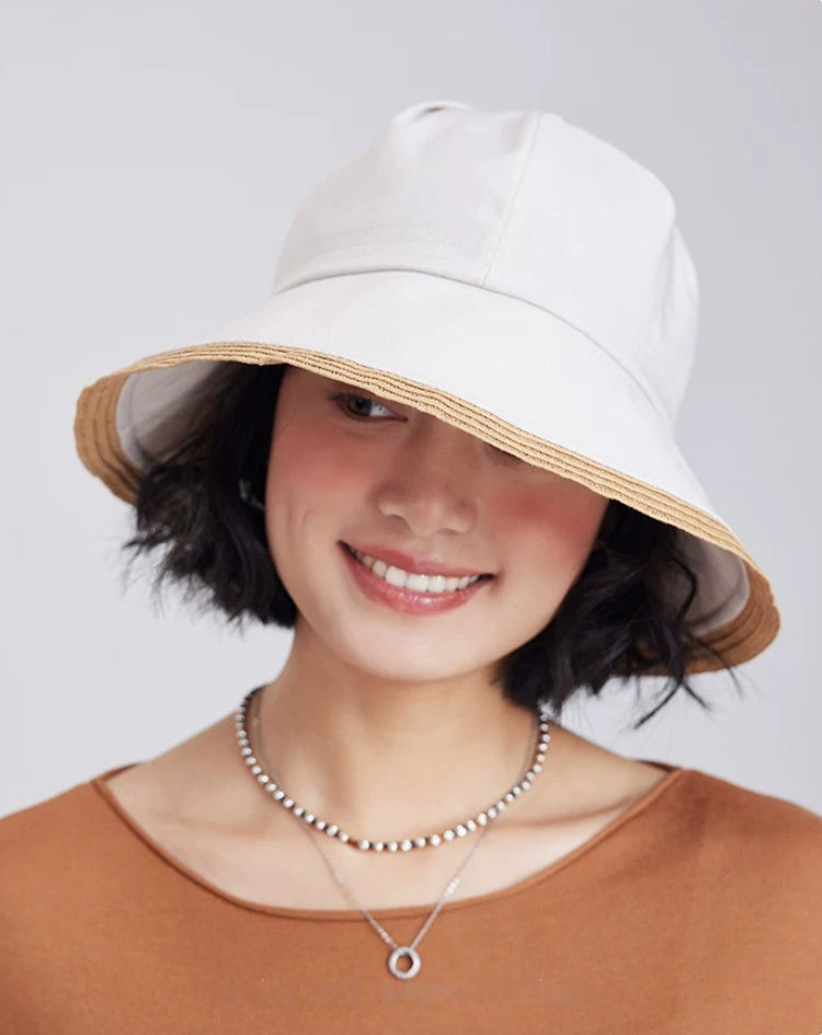model wearing an off-white wide brim sun hat with soft fabric crown for casual summer styling