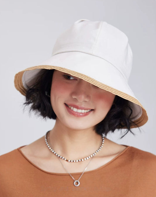 model wearing an off-white wide brim sun hat with soft fabric crown for casual summer styling