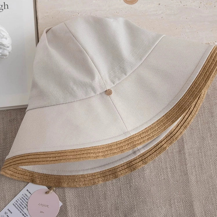 off-white summer sun hat with beige straw-style brim shown in close-up detail