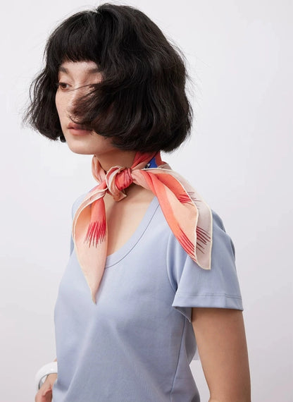 Lightweight pink silk square scarf styled as a spring summer neck scarf