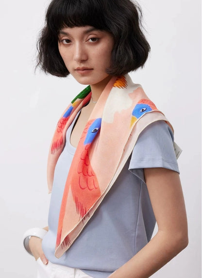 Model wearing pink floral bird mulberry silk scarf with soft romantic styling