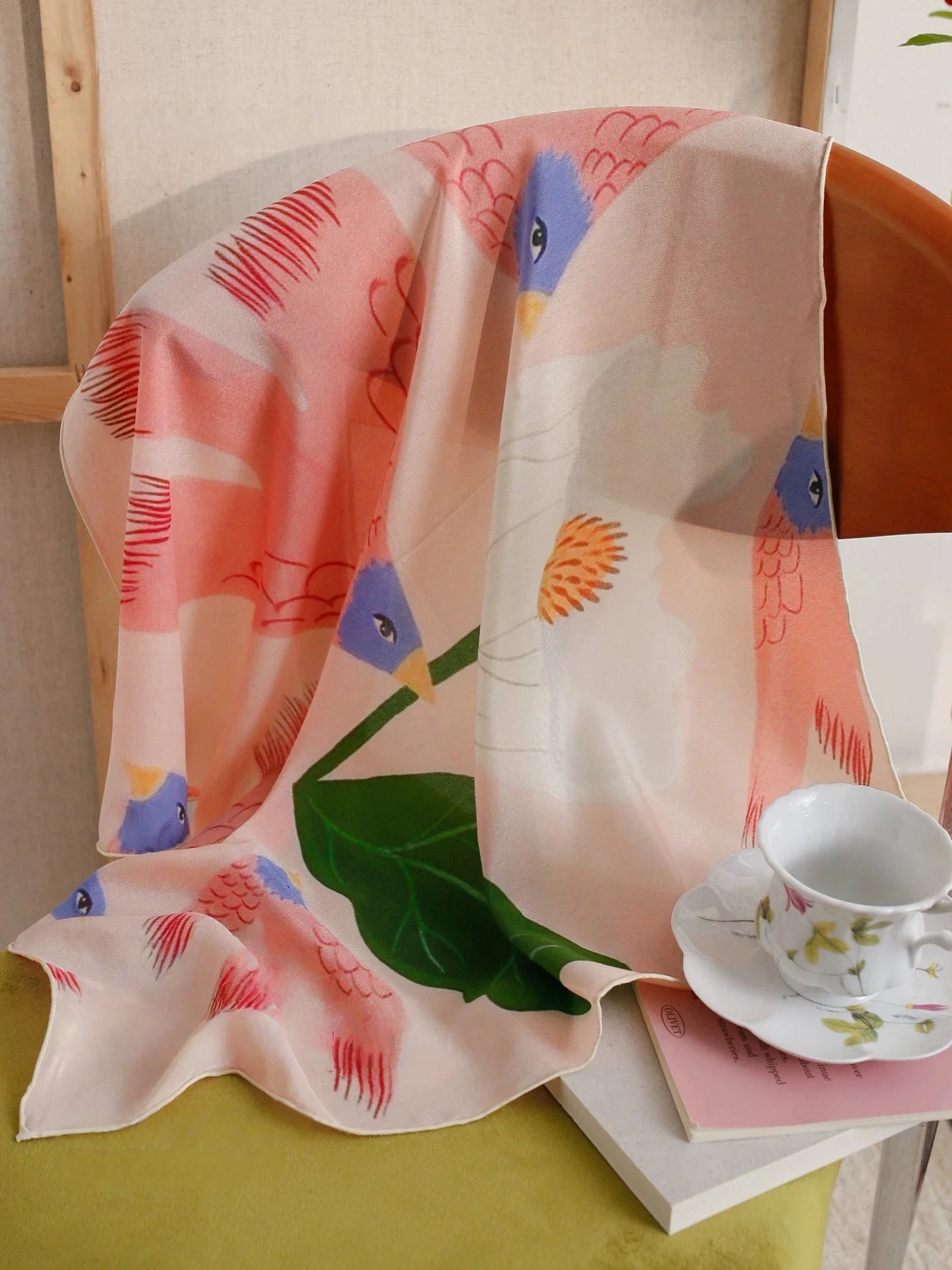 Pink bird and floral silk square scarf displayed as elegant home and gift accessory