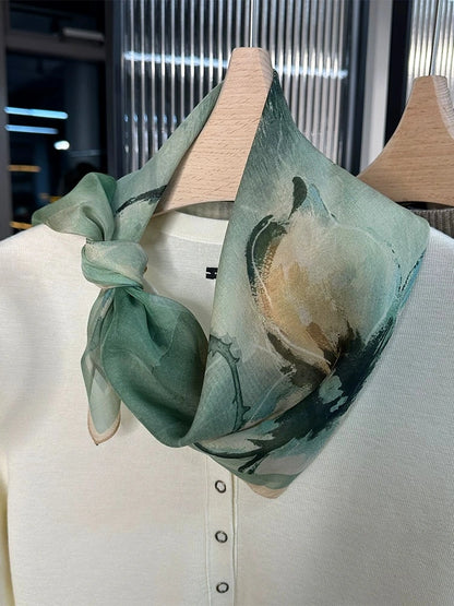 Mulberry silk square scarf with abstract green floral print, wrapped around neck for soft drape styling